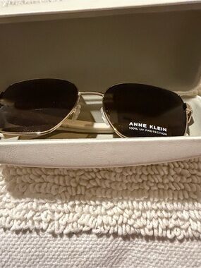 Anne Klein Gold Metal Frame Sunglasses with Dark Brown Lenses